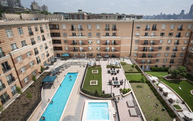 a pool in a courtyard between buildings