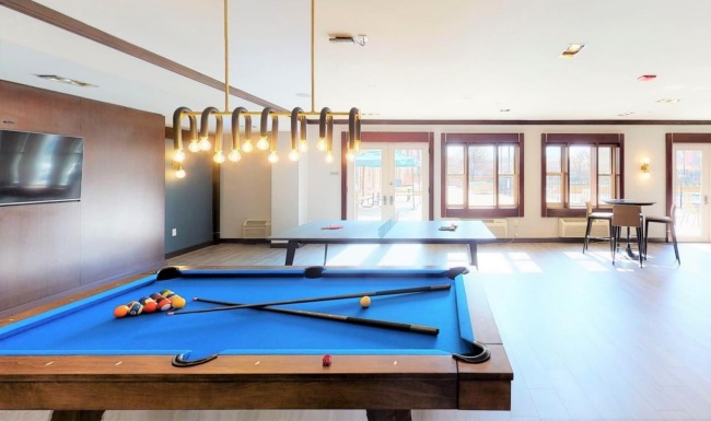 a open-style room with a pool table