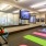 a room with exercise equipment and a tv on the wall