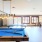 a room with pool tables and chairs