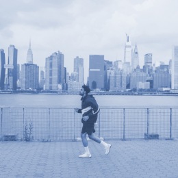 a man running in front a city